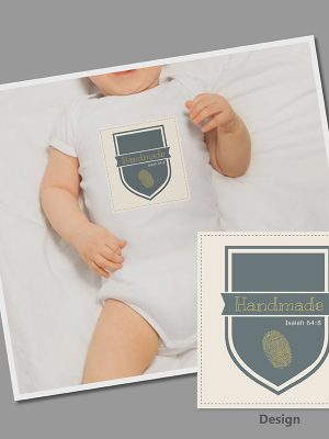 Pic of a personalised babygrow featuring the Bible verse Isaiah 64:8 and the words Handmade